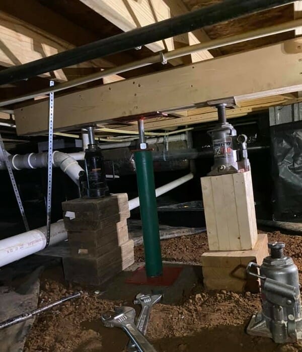 Foundation jackstands in a crawlspace